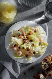 Delicious salad with Chinese cabbage, shrimps and pineapple served on grey table, flat lay