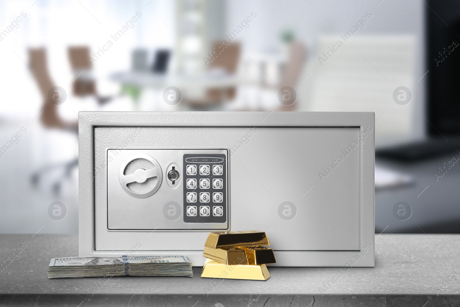 Image of Closed steel safe with electronic lock, money and gold bars on grey table indoors