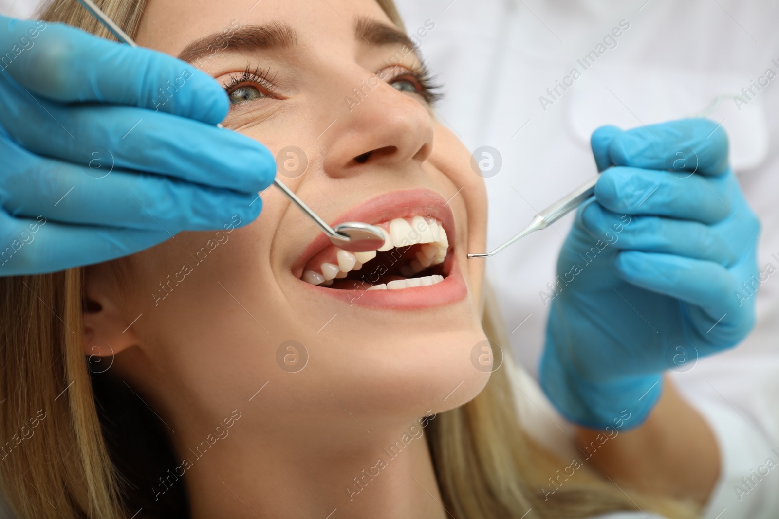 Photo of Doctor examining patient's teeth, closeup. Cosmetic dentistry