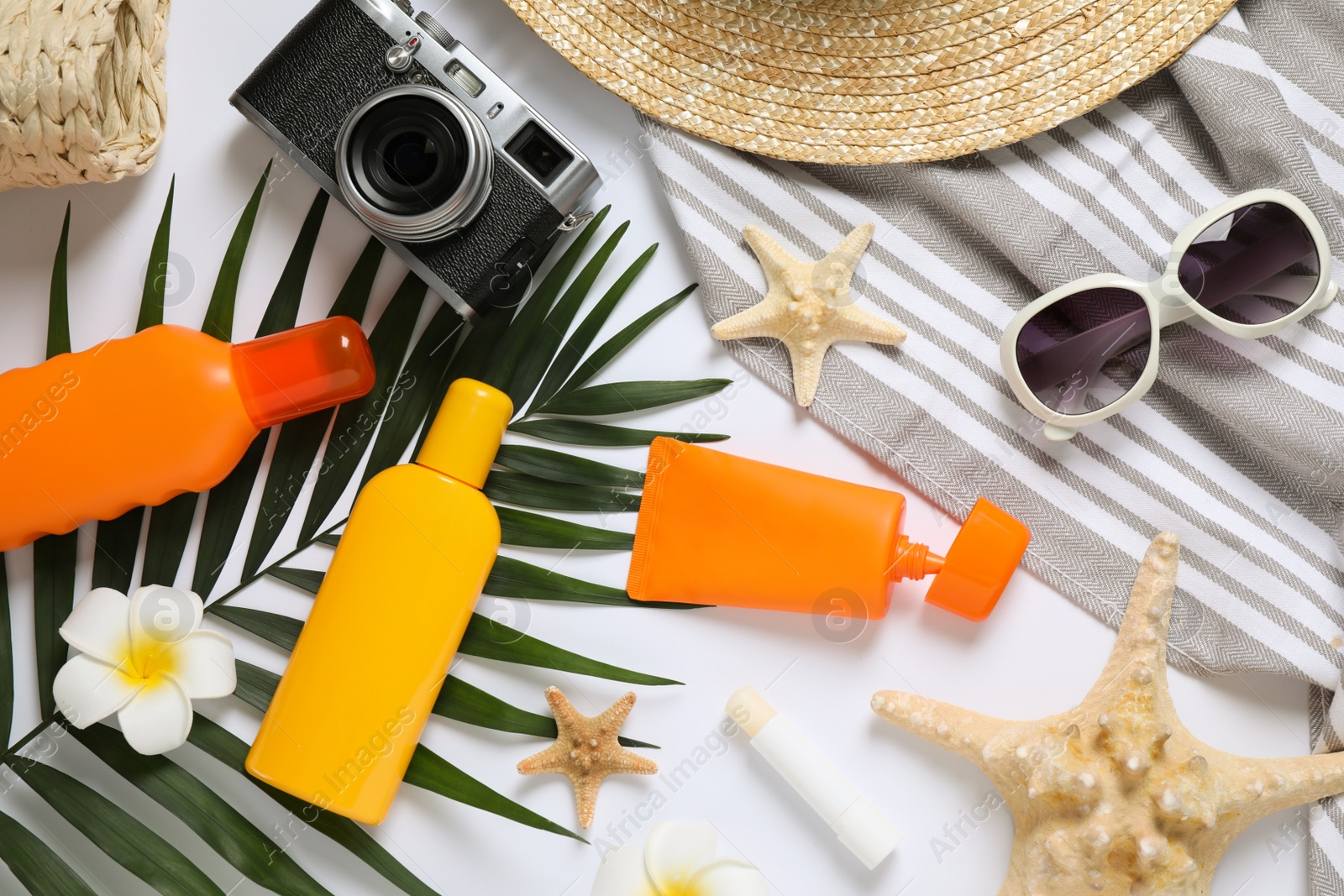 Photo of Composition with sun protection products and beach accessories on white background, top view