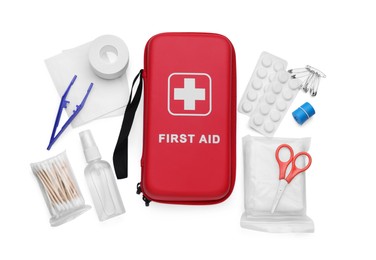 Photo of Red first aid kit, scissors, pins, cotton buds, pills, plastic forceps, hand sanitizer and medical plaster isolated on white, top view
