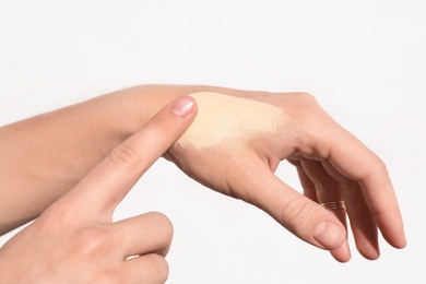 Woman testing foundation tone on hand, closeup