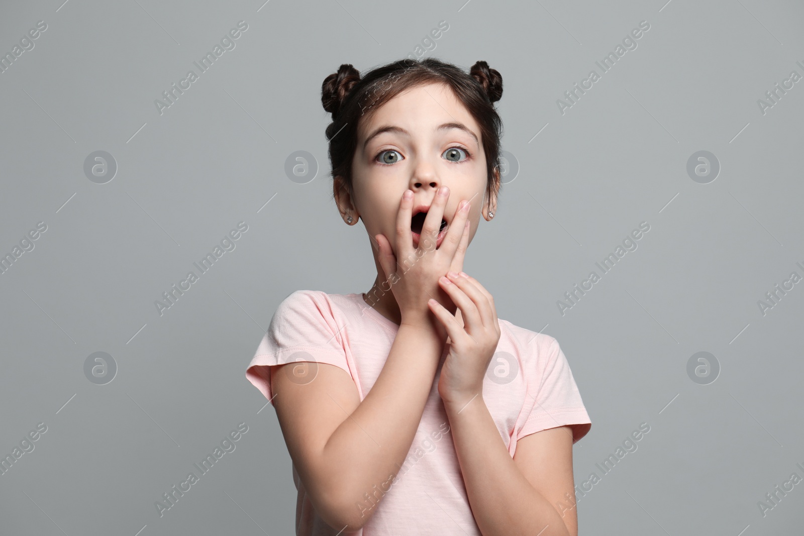 Photo of Little girl feeling fear on grey background