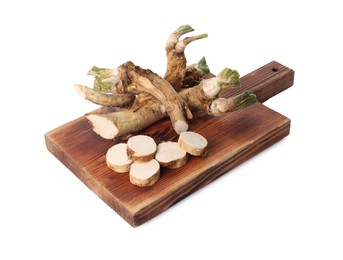 Photo of Board with fresh cut horseradish roots isolated on white