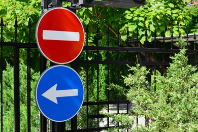 Post with No Entry sign and arrow outdoors on sunny day, space for text