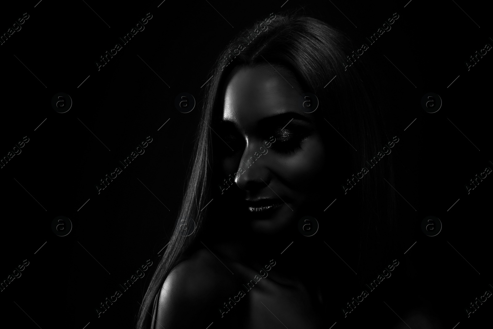 Image of Silhouette of woman in darkness. Portrait on black background