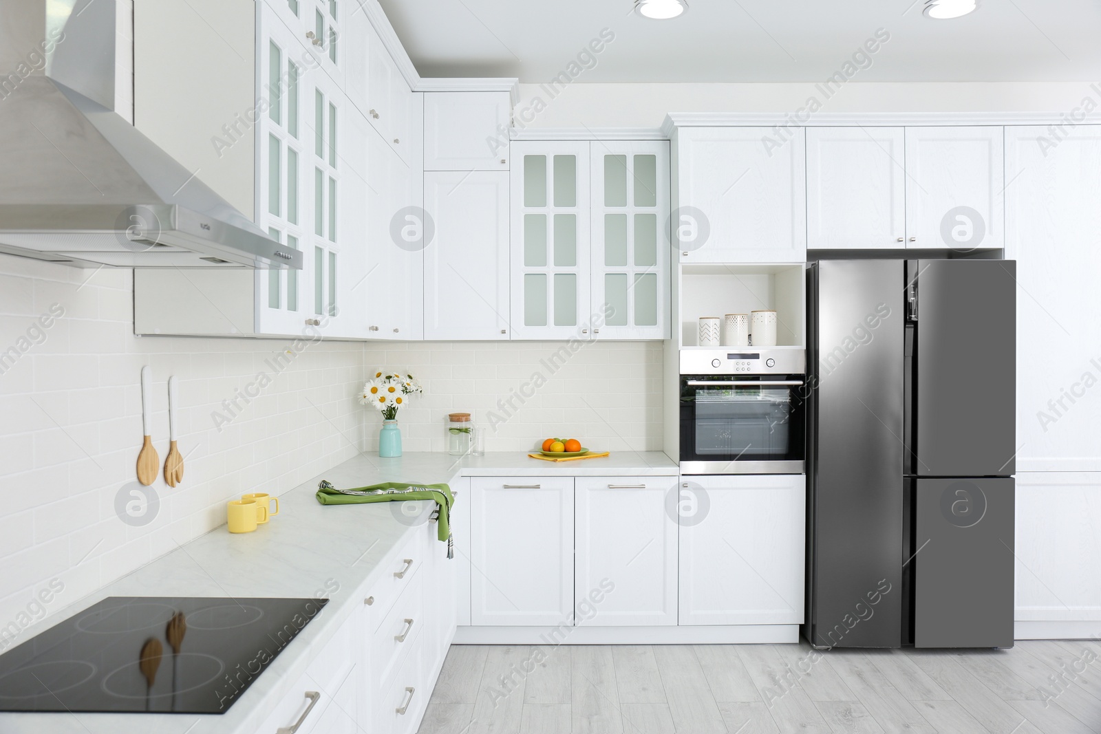 Photo of Modern kitchen interior with stylish white furniture