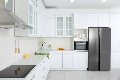 Photo of Modern kitchen interior with stylish white furniture