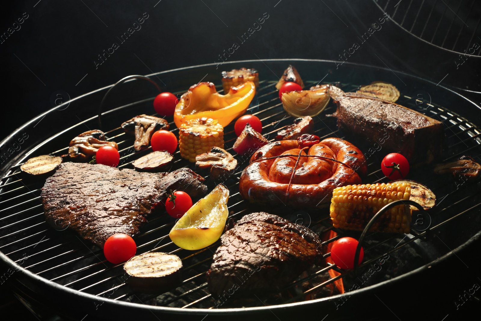 Photo of Assorted delicious meat and vegetables on barbecue grill