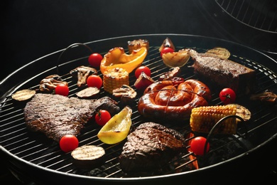 Photo of Assorted delicious meat and vegetables on barbecue grill