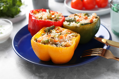 Photo of Tasty stuffed bell peppers on grey table