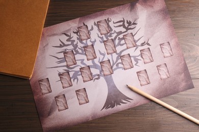 Photo of Blank family tree, notebook and pencil on wooden table, flat lay