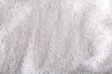 Photo of White foam with bubbles as background, top view