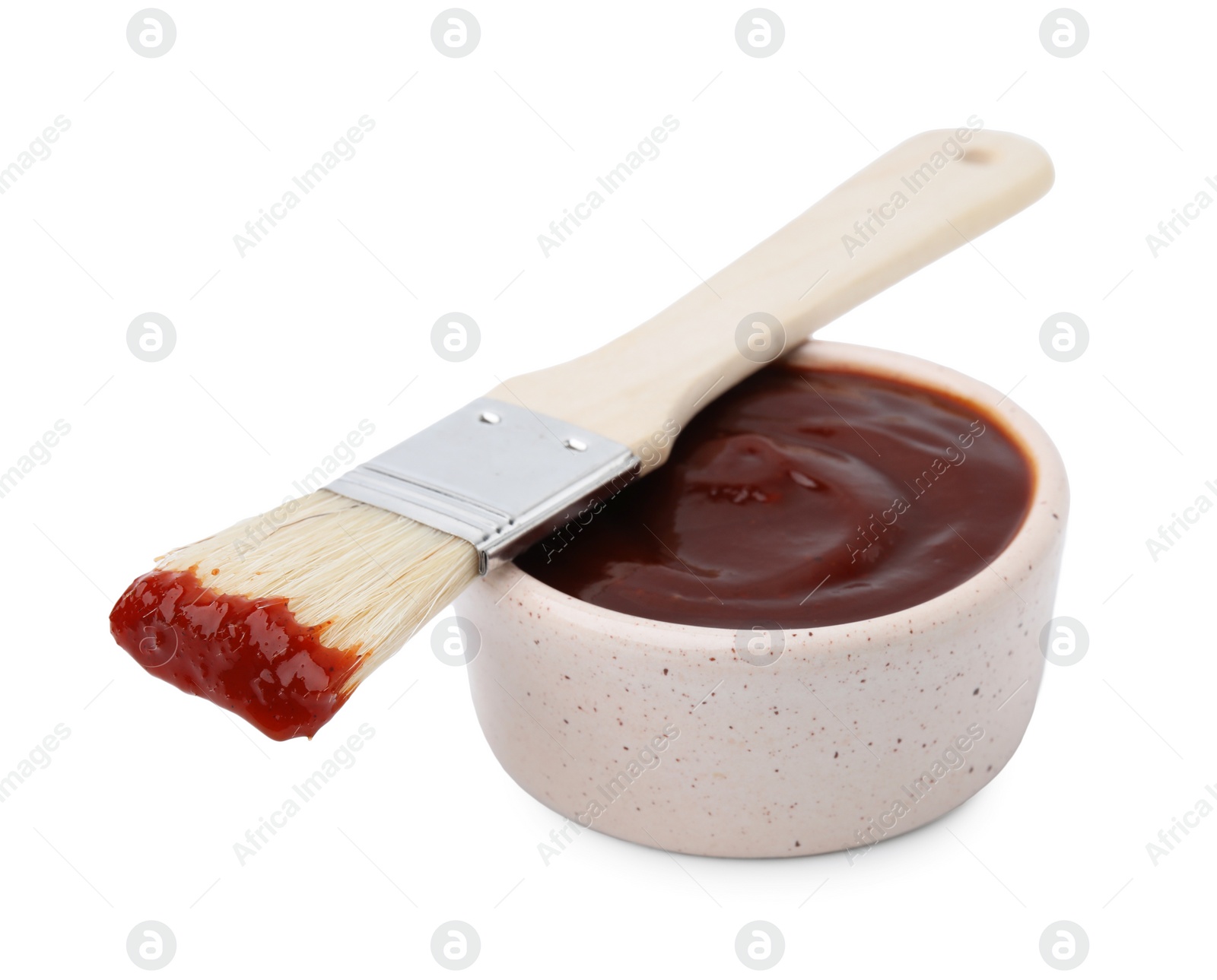 Photo of Marinade in bowl and basting brush isolated on white