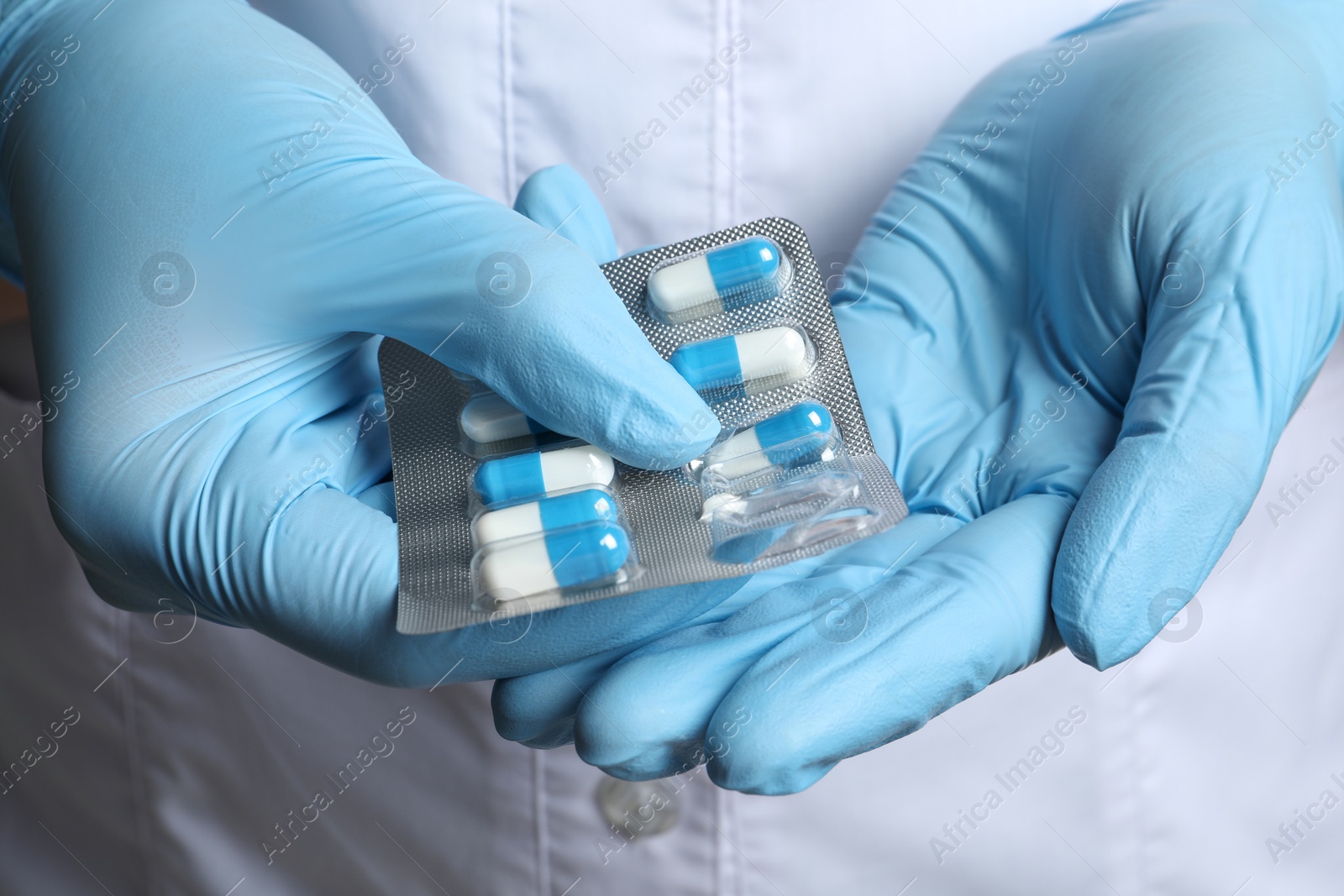 Photo of Doctor taking pill out from blister pack, closeup