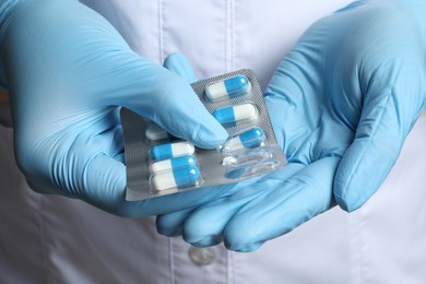 Photo of Doctor taking pill out from blister pack, closeup