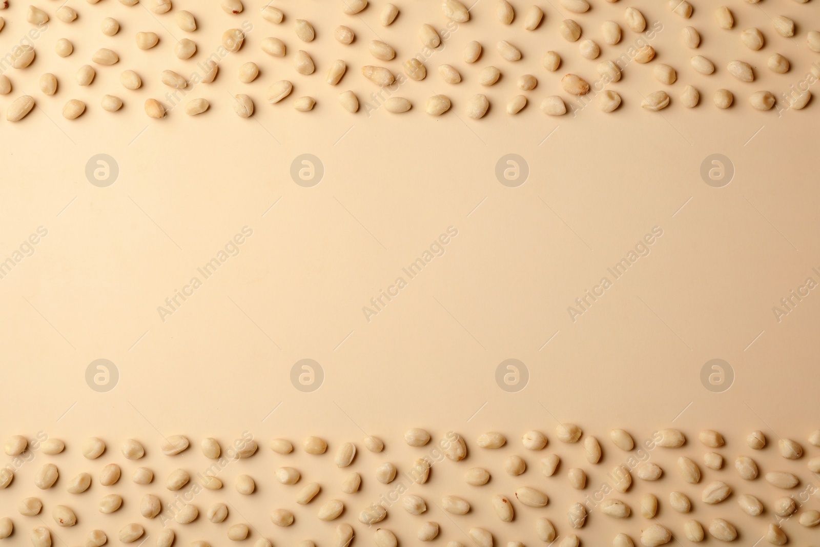 Photo of Composition with peanuts and space for text on color background, top view