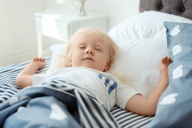 Cute little girl sleeping in bed at home