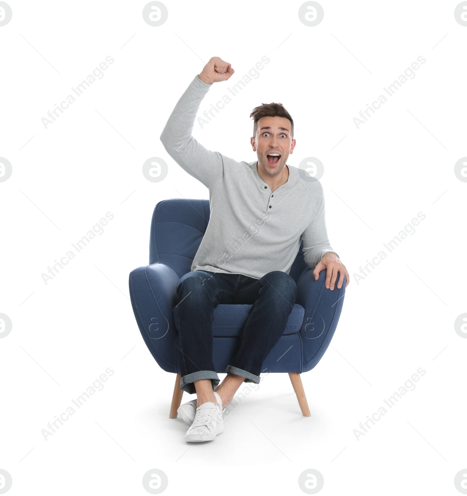 Photo of Emotional young man sitting in armchair on white background