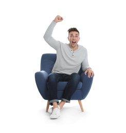 Photo of Emotional young man sitting in armchair on white background