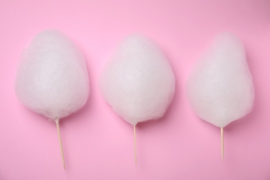 Photo of Flat lay composition with sweet cotton candies on pink background