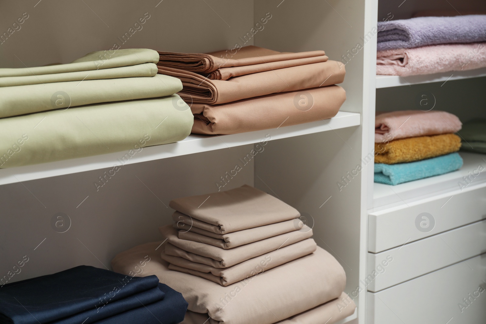 Photo of Different colorful bed linens on display in home textiles store