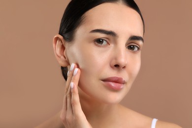 Woman with dry skin on beige background, closeup