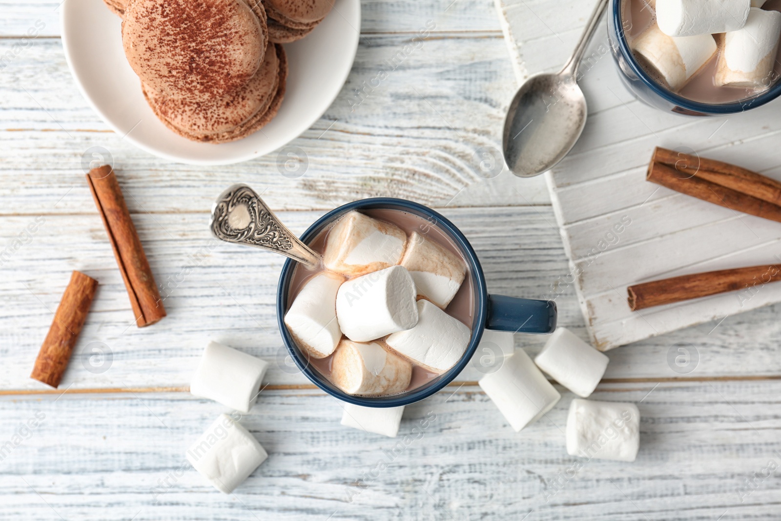 Photo of Flat lay composition with delicious hot cocoa drink and marshmallows on table