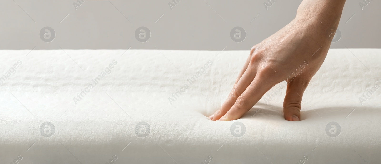 Image of Woman touching memory foam pillow, closeup. Banner design with space for text