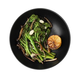 Photo of Tasty cooked broccolini with lemon and mushrooms isolated on white, top view