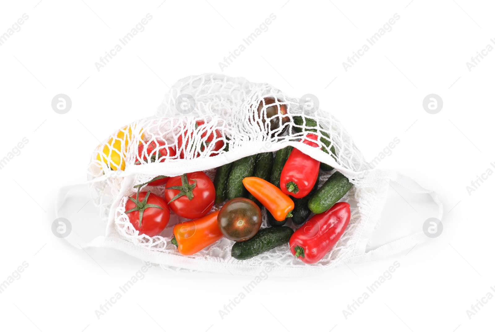 Photo of String bag with different vegetables isolated on white