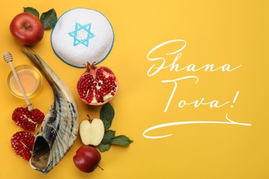 Flat lay composition with Rosh Hashanah holiday attributes on yellow background 