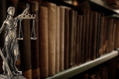 Image of Law and wisdom. Statue of Lady Justice near shelves with books, space for text