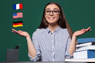 Image of Portrait of foreign languages teacher at table and different flags green chalkboard