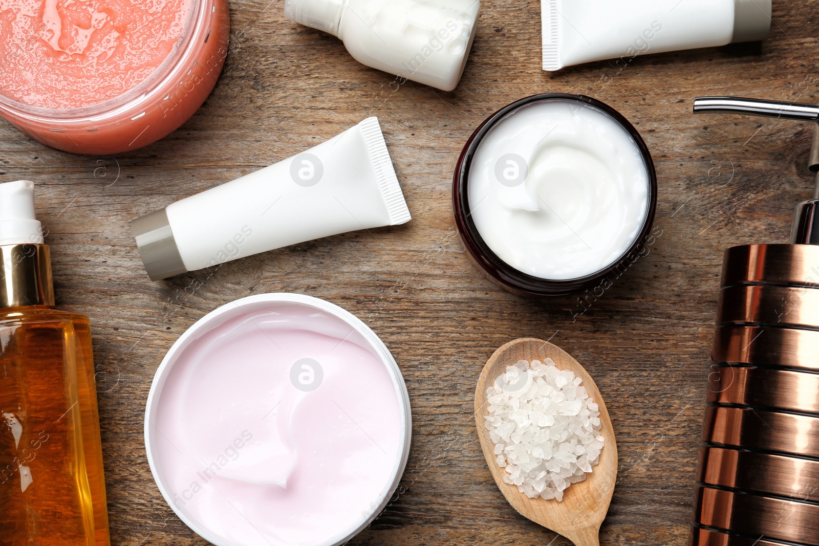 Photo of Flat lay composition with body care products on wooden background