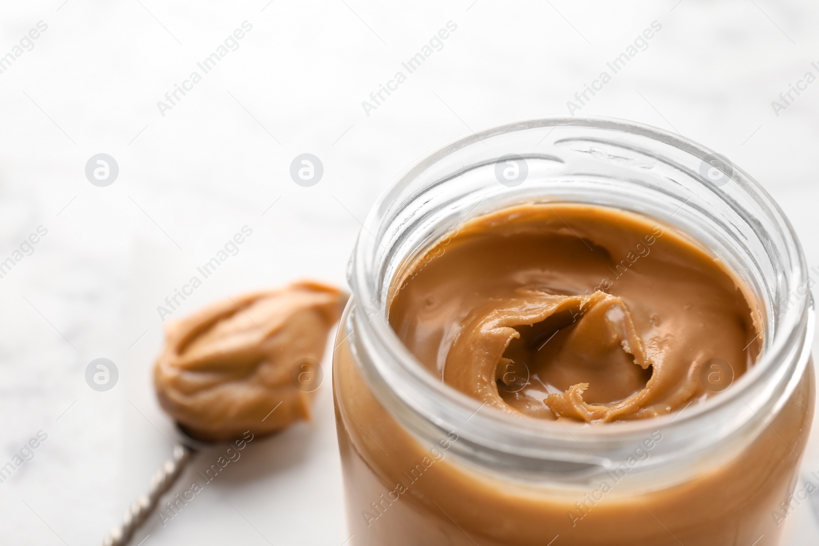 Photo of Jar with creamy peanut butter, closeup