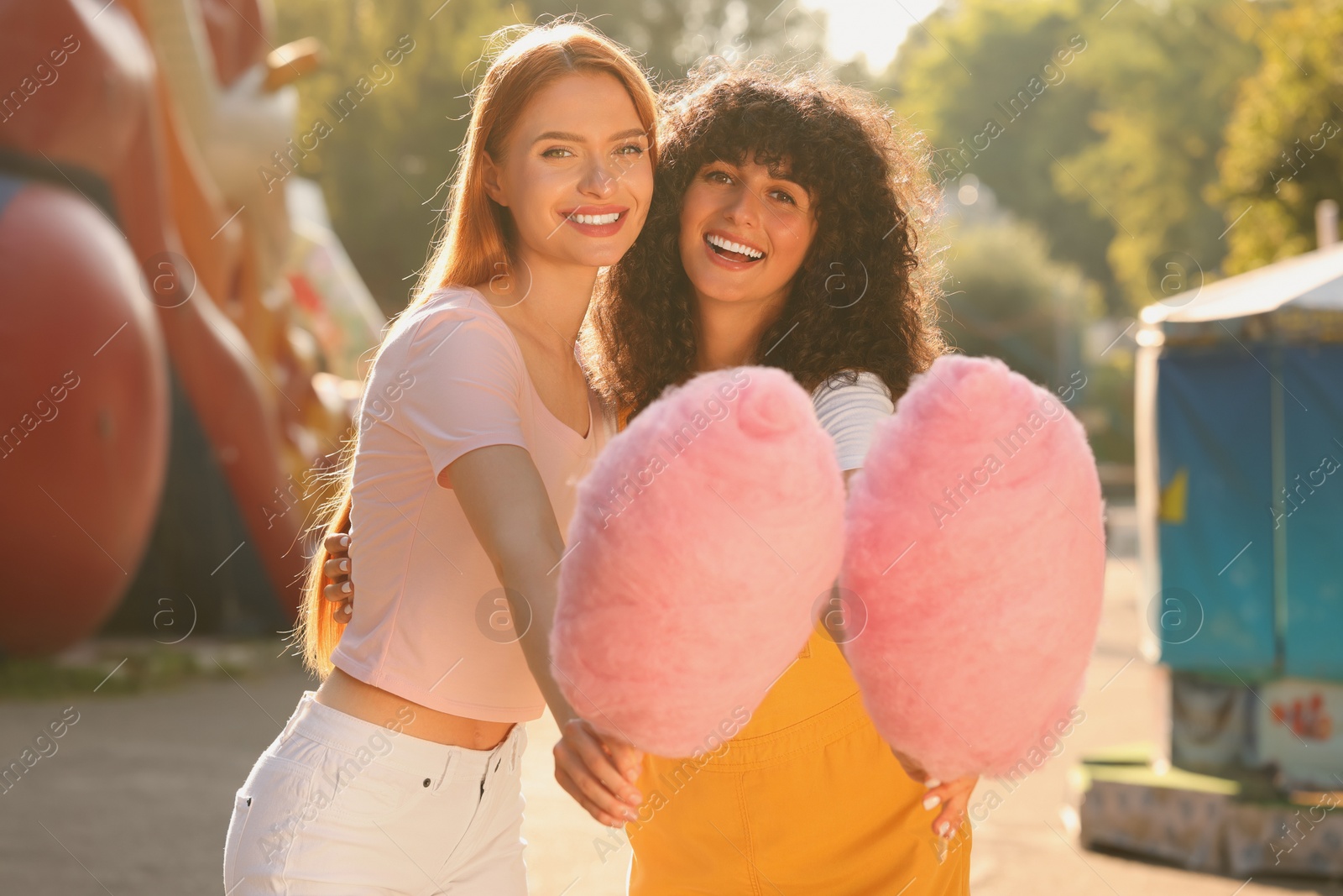 Photo of Happy friends with cotton candies outdoors on sunny day