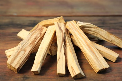 Many palo santo sticks on wooden table, closeup