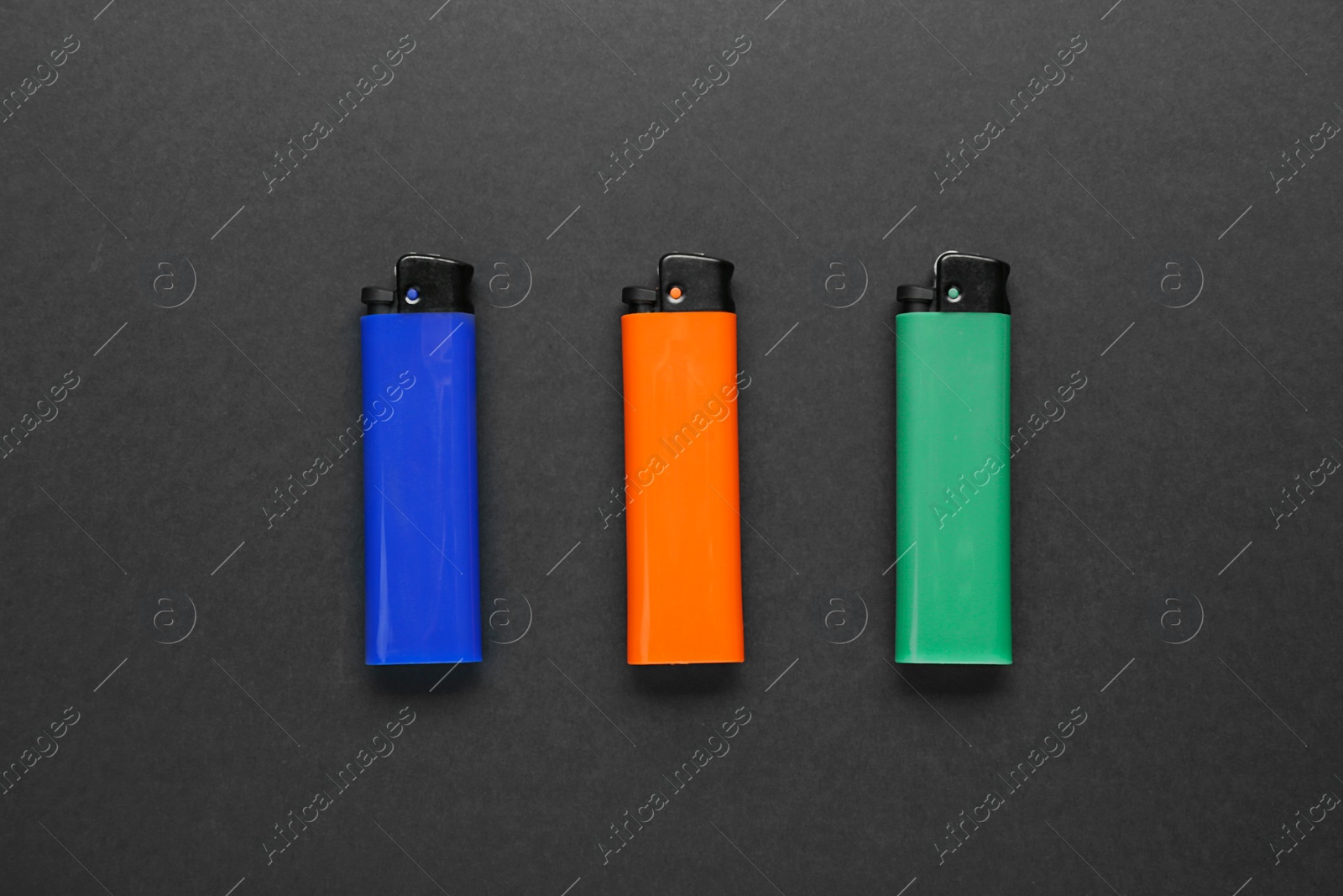 Photo of Stylish small pocket lighters on black background, flat lay