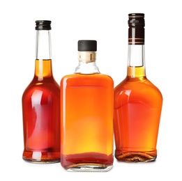 Photo of Bottles of scotch whiskey on white background