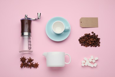 Photo of Flat lay composition with manual coffee grinder and beans on pink background