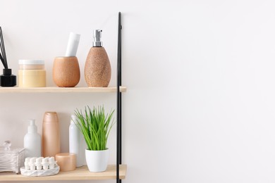 Photo of Different bath accessories, personal care products and artificial plant indoors, space for text
