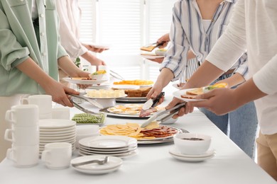 Photo of People taking food during breakfast, closeup. Buffet service