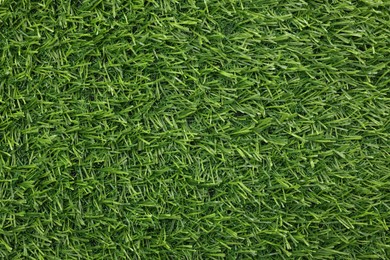 Photo of Green artificial grass as background, top view