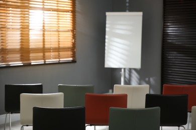 Empty conference hall with whiteboard and chairs