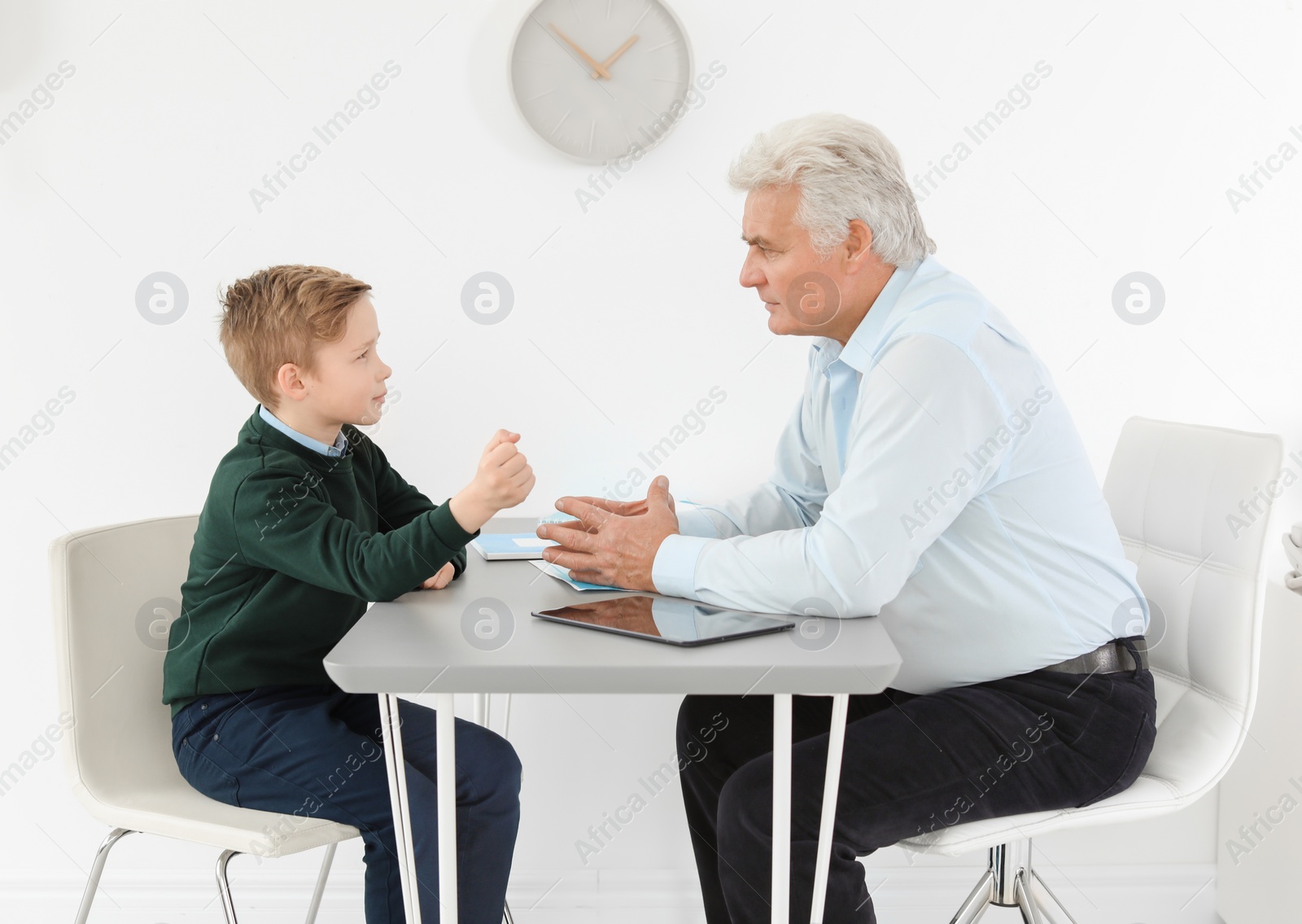 Photo of Little boy having appointment at child psychologist office