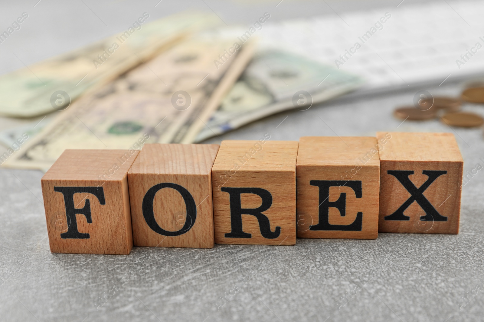 Photo of Word Forex made of wooden cubes with letters on grey table, closeup