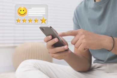 Image of Man leaving service feedback with smartphone at home, closeup. Stars and emoticon over device