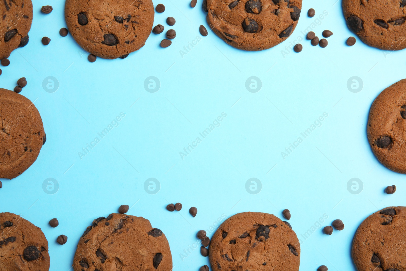 Photo of Delicious chocolate chip cookies on color background, flat lay. Space for text