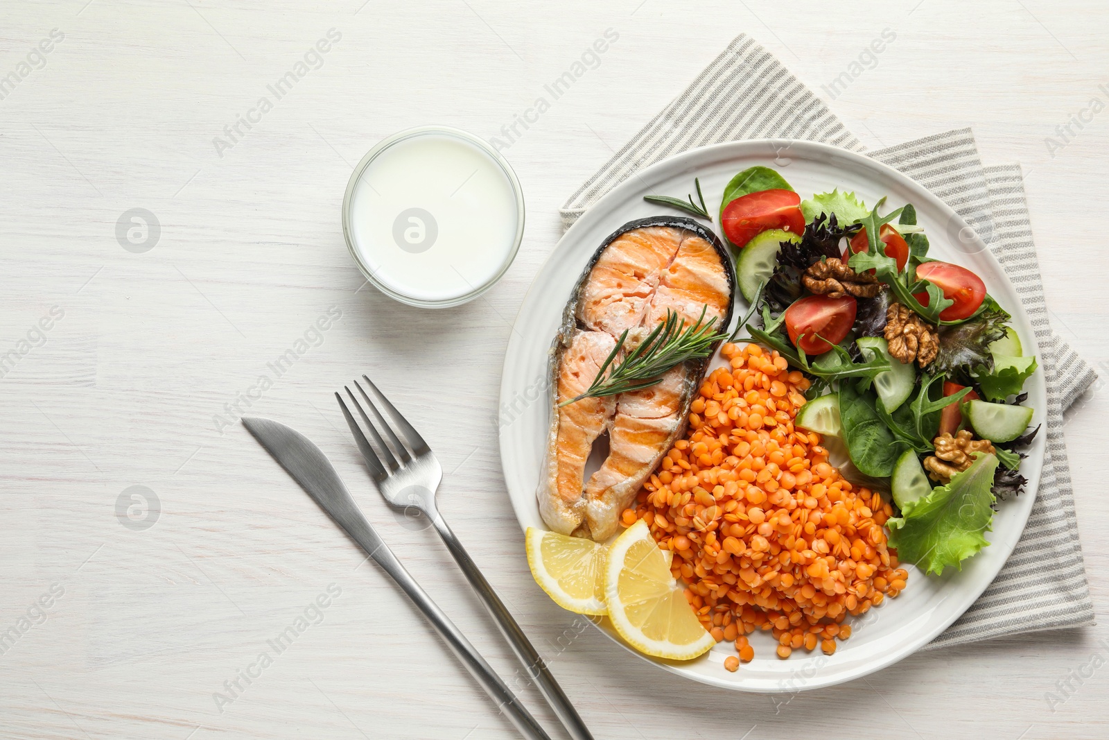 Photo of Plate with healthy food high in vegetable fats served on light wooden table, flat lay. Space for text